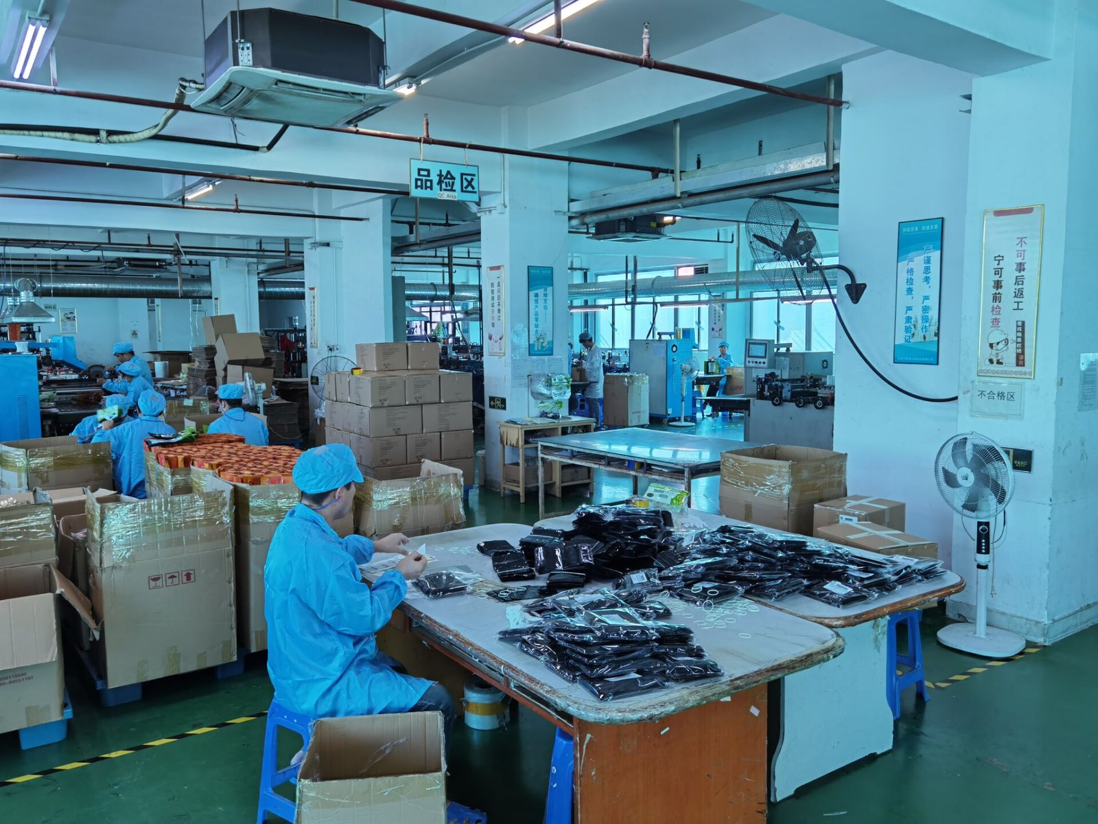 Factory worker inspecting stitching on a cosmetic bag