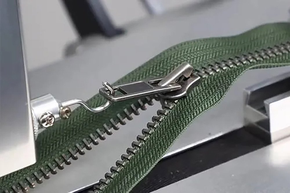 Testing zipper smoothness on fabric sample
